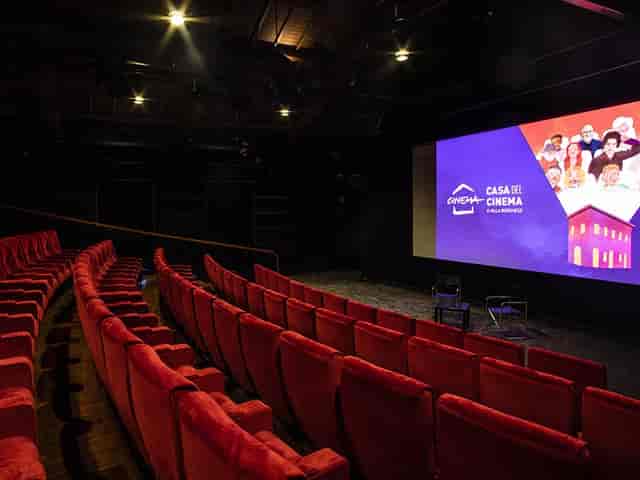 Sala Cinecittà: plush red seating and large screen for film screenings and events.