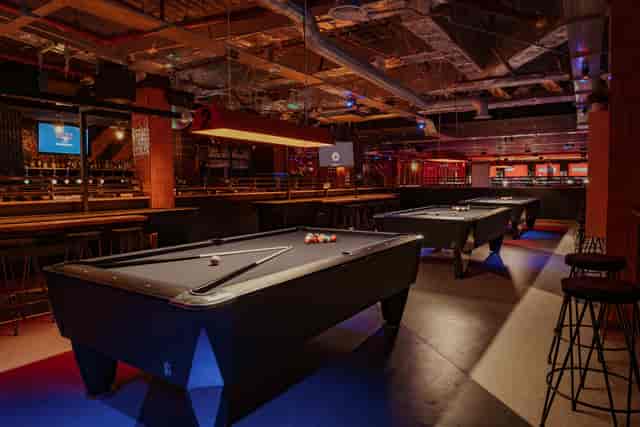 Stylish gaming hall with pool tables for networking events in London.