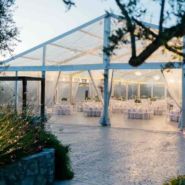 Clear-span tent wedding at Lapatsa Countryside Venue featuring elegant white drapery for upscale galas.