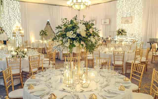 Ledra Ballroom gala with gold chairs and fairy-light decor for corporate events or weddings.