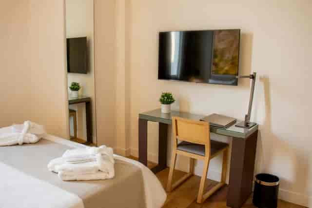 Michael Angelo hotel guest room with dedicated workspace for corporate travel and remote work.