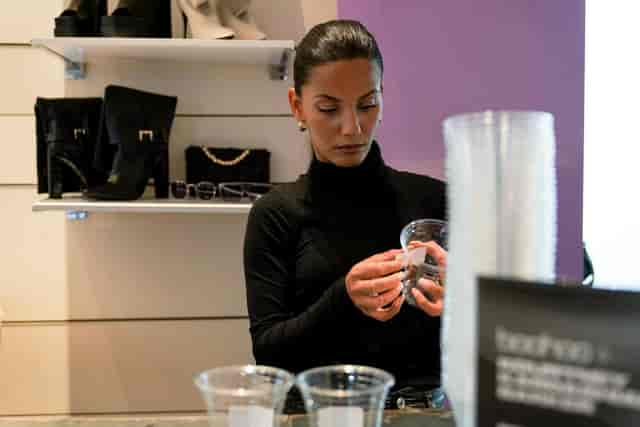 Pearl Lemon Catering staff polishing glassware for a brand pop-up or retail activation event.