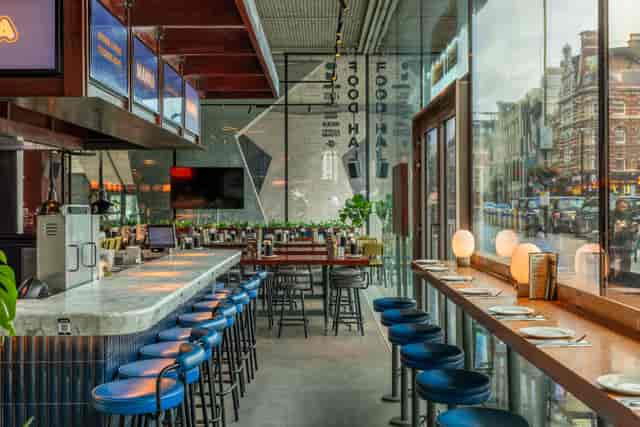 Modern restaurant with vibrant ambiance, ideal for casual meetings and networking events.