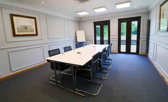 Modern meeting room in Old Thorns, featuring a long table for conferences and presentations.
