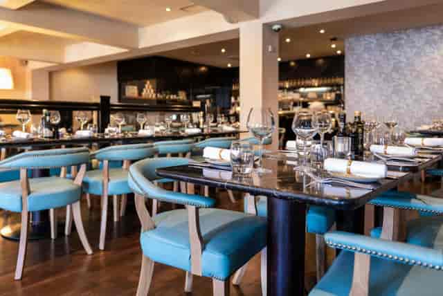 Private dining room in Piccolino Mayfair with teal seating for corporate dinners and networking.