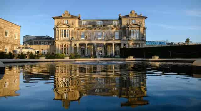 Elegant venue at Down Hall Hotel & SPA with serene water reflection for events.