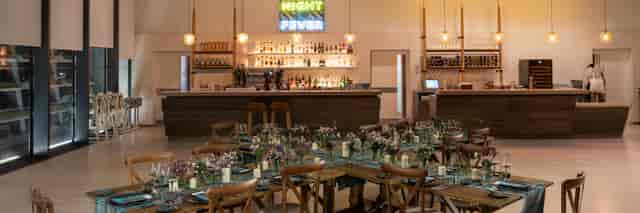 V&A Dundee Upper Foyer: rustic-chic venue with neon bar for corporate mixers and receptions.