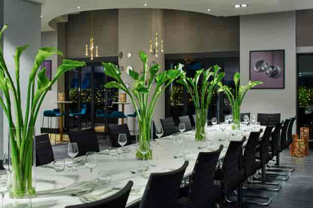 Boardroom at London Marriott Maida Vale with calla lilies for corporate meetings and dinners.