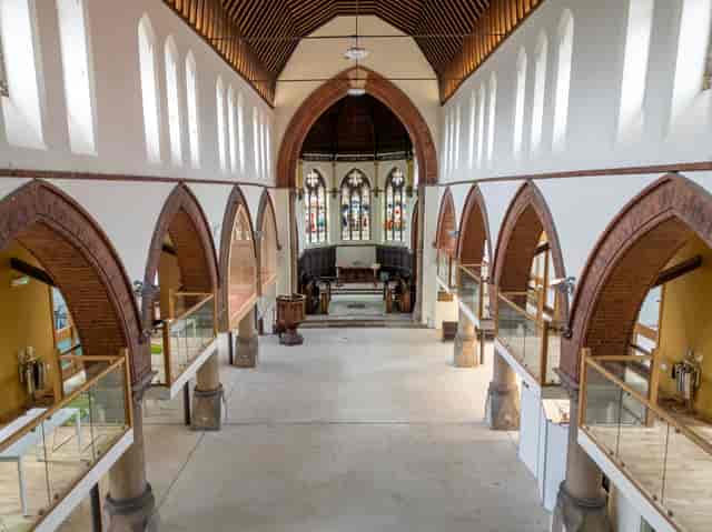 Business event venue with high ceilings and stained glass in St Matthew's Community Centre.