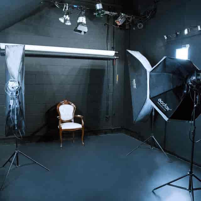 Minimalist white photography studio with elegant chair for corporate events and branding.