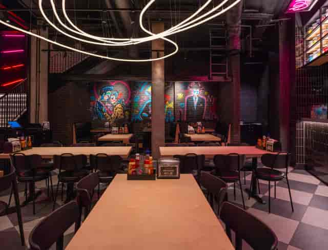 Black Tap urban venue with mural decor, ideal for edgy corporate mixers and team-building dinners.