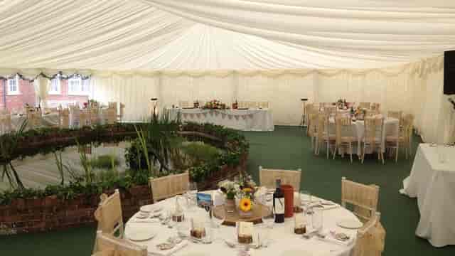 Rustic marquee wedding venue at The Coppleridge Inn with indoor garden pond feature.