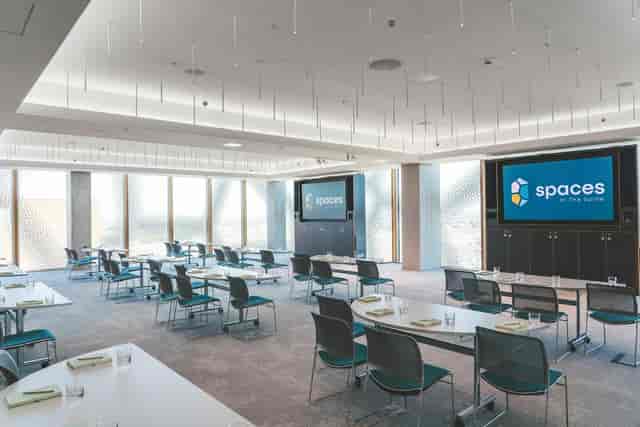 Modern meeting room with floor-to-ceiling windows, ideal for corporate events and workshops.