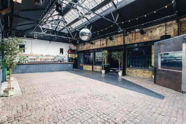 Spacious Electrowerkz venue with polished brick flooring for events and gatherings.