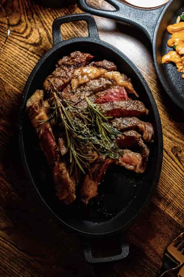 High-end main course at CARNE HOVE, rustic-chic plating for executive dinner or gala menu.