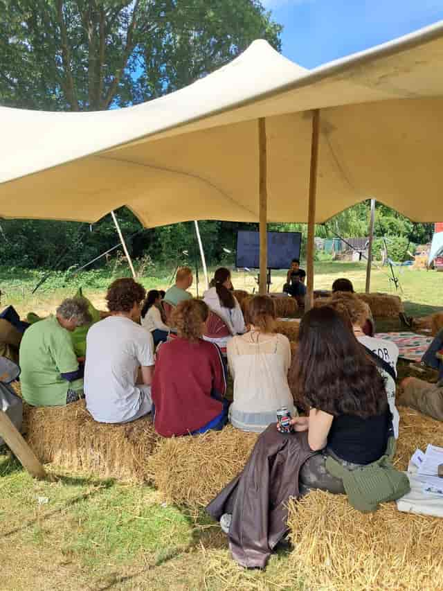 Stretch Bonga tent at Birmingham nature centre with hay-bale seating for rustic outdoor events.