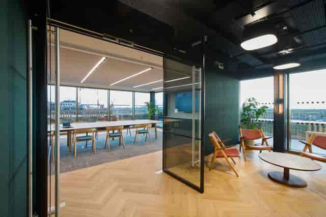 High-end hybrid boardroom and breakout lounge for corporate offsite meetings.