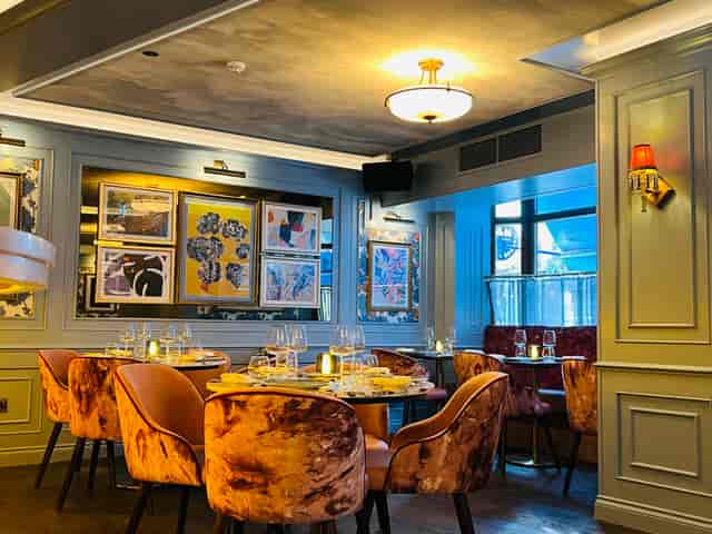 Upscale Brook Bar venue with velvet seating for corporate dinners and event hosting.