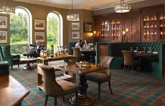Upscale hotel lounge with booth seating for executive networking and VIP event breakouts.