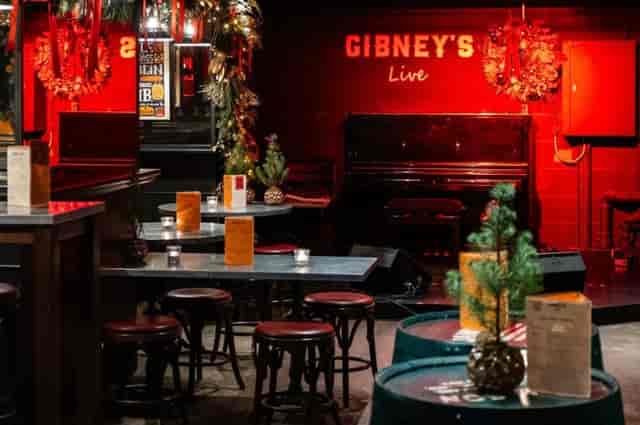 Gibney's London bistro-style barrel seating for cozy holiday reception networking events.