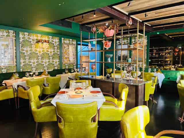 Meadow Private Room: Lime-green seating, chic decor for corporate dinners and boutique events.