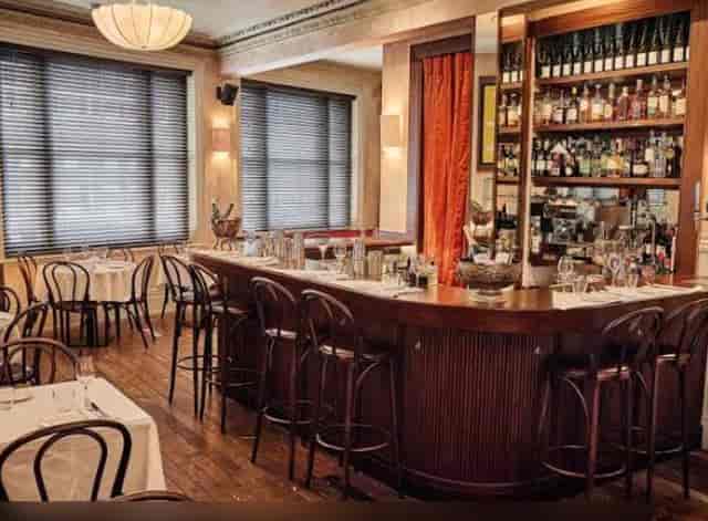 Sophisticated restaurant bar for events with warm lighting and ample seating.