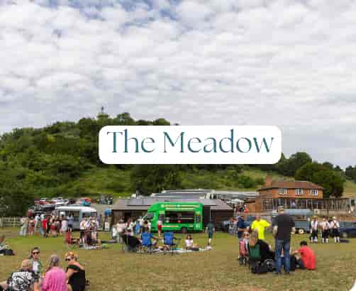 Outdoor event at The Walled Garden, featuring food trucks and spacious seating.