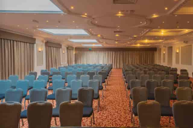 Grand Prix Suite at Whittlebury Park: elegant conference space with blue chairs and natural light.