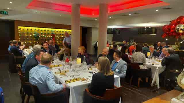 Elegant banquet setup at Cilantro for networking event, warm ambiance, fine dining.