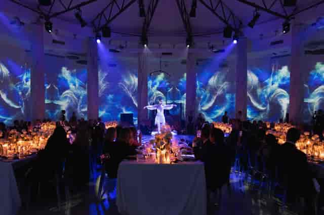 Elegant gala dinner setting in IL SALONE DELLE COLONNE with candles and floral decor.