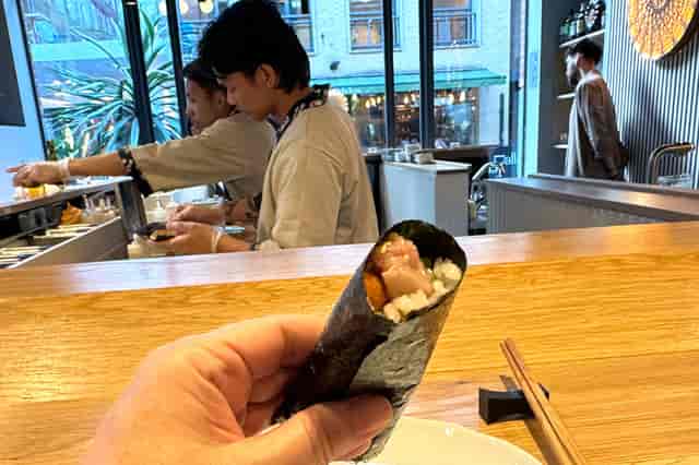 Sushi chef preparing rolls at Ukiyo Hand Roll Bar, ideal for catering and networking events.