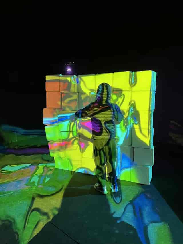 Rooftop bar interactive installation with vibrant illuminated backdrop for events.