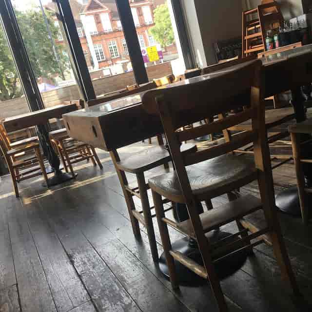 Flexible meeting space at Sarracino Restaurant with wooden furniture for events.