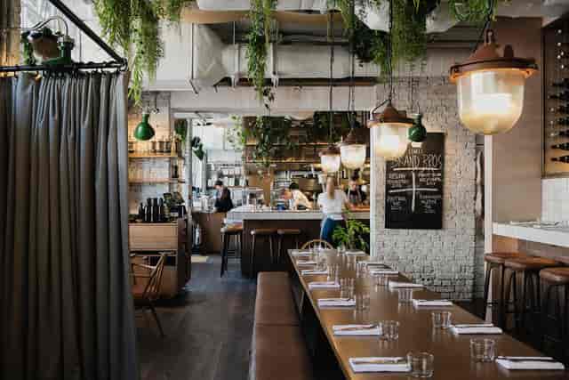 Modern Queen's Quarters restaurant with communal table, ideal for events and gatherings.