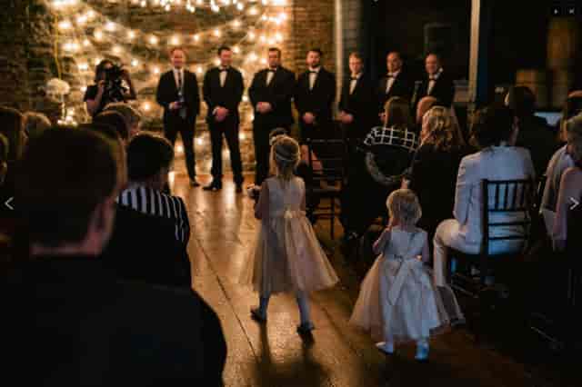 Charming wedding setup at UnderBelly with elegant backdrop and joyful children.
