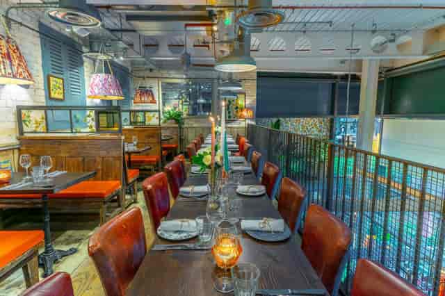 Cozy dining area at Bill's Exeter with a long wooden table, ideal for intimate events.
