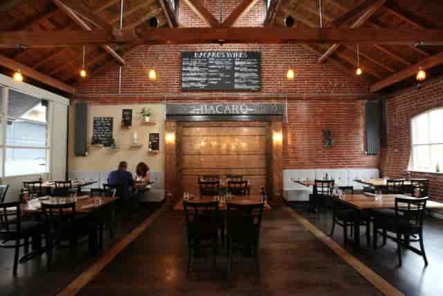 Versatile Bacaro venue with rustic brick walls, perfect for meetings and receptions.