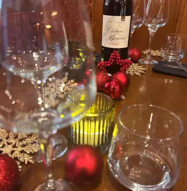 Elegant Christmas dining table with festive decor for a holiday gathering.