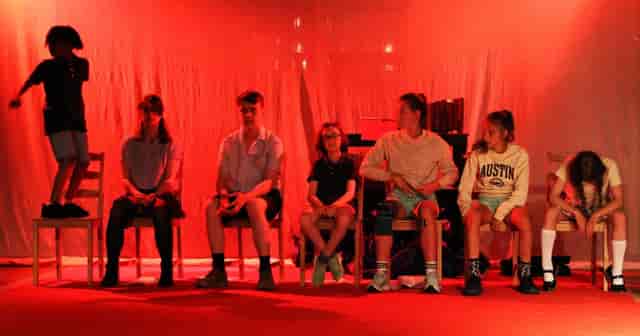 Seaside Gallery panel session with red lighting, poor AV, and event setup.
