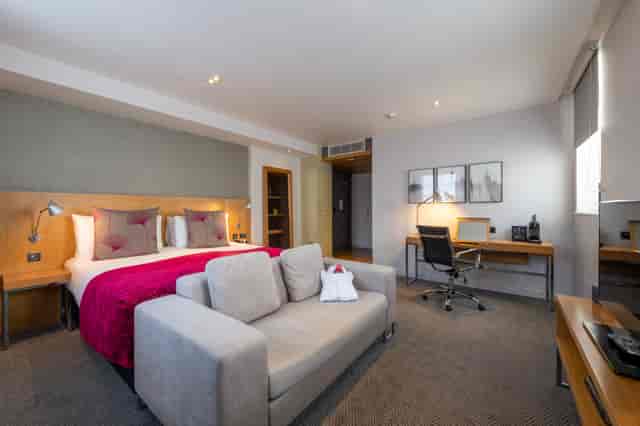 Comfortable hotel bedroom at Apex Temple Court for business travelers and events.