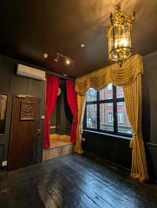 Intimate breakout space with stage at 41 Whitfield Street for private events and presentations.