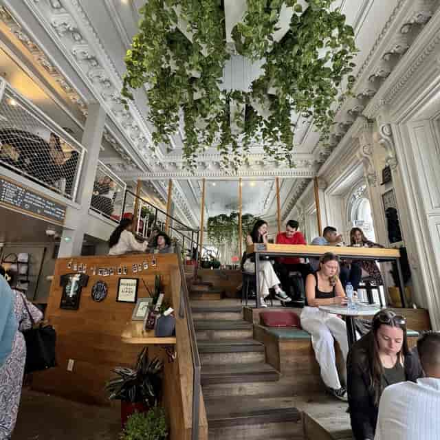 Trendy upstairs bar venue with natural light, ideal for meetings and networking events.