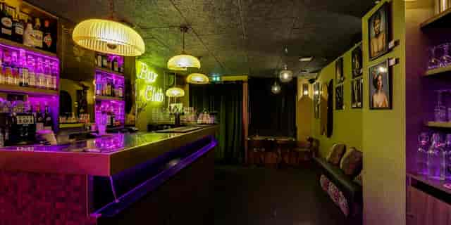 Vibrant Le Cancan Pigalle venue with neon lights, ideal for cocktail receptions and gatherings.