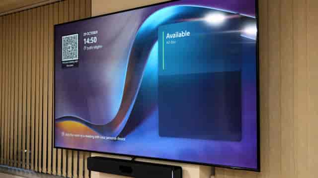 Blue Room booking display showing real-time space availability for hybrid office collaboration.