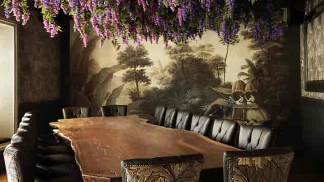 Boardroom private dining room with wood table and floral decor for intimate business meetings.