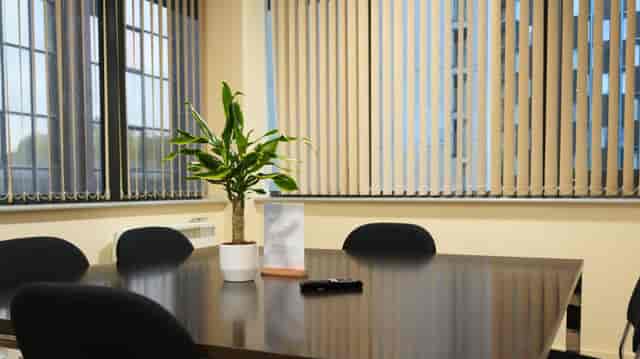 Orange Room breakout space with sterile design for professional meetings and office workshops.