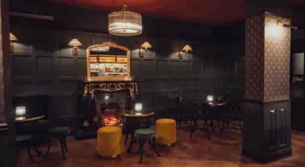Elegant event space at 135 Bar & Lounge, featuring cozy fireplace, ideal for gatherings.