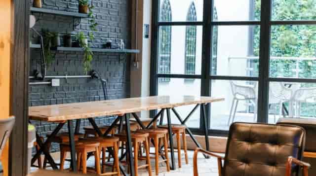 Sleek meeting space with wooden table for creative brainstorming sessions in Film + TV Charity