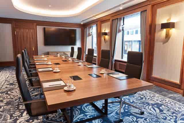 Modern conference room with wooden table and ergonomic chairs at Steigenberger Frankfurter Hof.