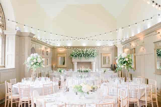 Elegant banquet hall at Enchanted Chapel, romantic wedding venue with floral centerpieces.